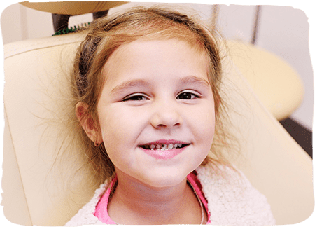 Young girl smiling in dental chair at pediatric dentistry office