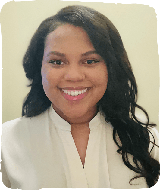 Smiling woman in white professional attire against neutral background, pediatric dentistry office setting.